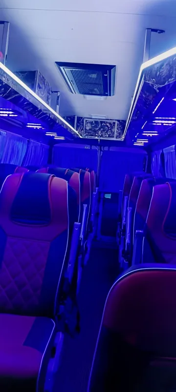 SelectBus 17-seater AC Tempo Traveller night interior with ambient lighting
